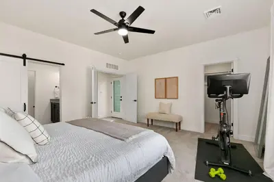 a bedroom with a bed and a ceiling fan at Coastal Chic Home near New Belgium & Old Town FC in Fort Collins