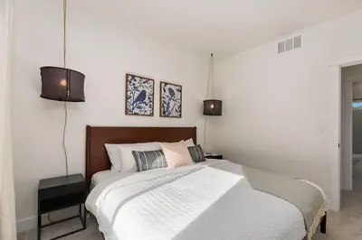 a bedroom with a large bed and two lights at Coastal Chic Home near New Belgium & Old Town FC in Fort Collins