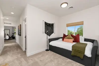 a bedroom with a large bed with red pillows at Coastal Chic Home near New Belgium & Old Town FC in Fort Collins