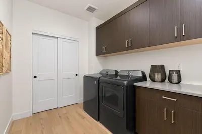 a laundry room with a washer and dryer in it at Coastal Chic Home near New Belgium & Old Town FC in Fort Collins