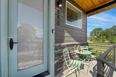 a patio with a table and chairs next to a door at Coastal Chic Home near New Belgium & Old Town FC in Fort Collins