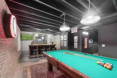 a billiard room with a pool table and a bar at Coopers North in Old Town - Hot Tub & Pool Table! in Fort Collins