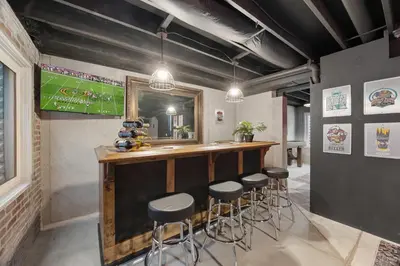 a bar in a room with stools and a mirror at Coopers North in Old Town - Hot Tub & Pool Table! in Fort Collins