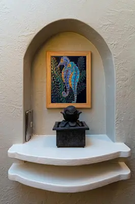 a shelf with a picture of a bird on a wall at Historic Mountain Ave Bungalow - Walk Everywhere! in Fort Collins
