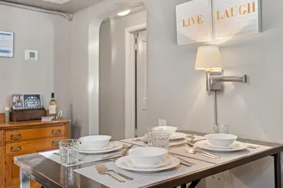 a table with plates and bowls on top of it at Garden Level Apt Mtn Ave - 8 min walk to Old Town! in Fort Collins
