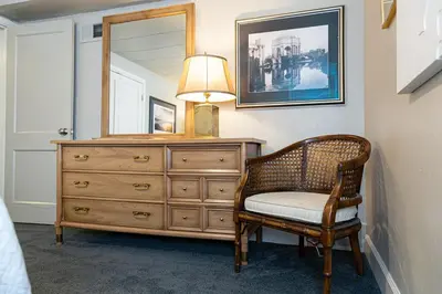 a dresser with a lamp and a chair in a room at Garden Level Apt Mtn Ave - 8 min walk to Old Town! in Fort Collins