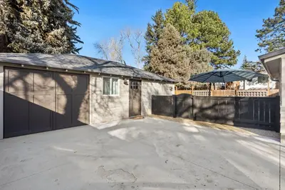 a house with a garage with an umbrella at Garden Level Apt Mtn Ave - 8 min walk to Old Town! in Fort Collins