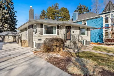 a large white house with a driveway at Garden Level Apt Mtn Ave - 8 min walk to Old Town! in Fort Collins
