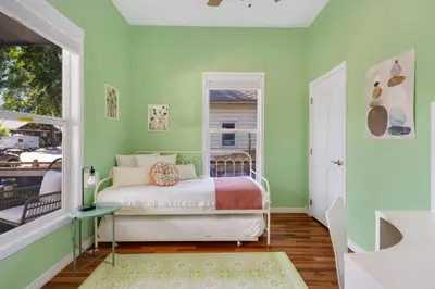 a bedroom with a bed and a window at The Magnolia House in Old Town - Private Hot Tub in Fort Collins
