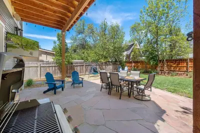 a patio with a table and chairs and a grill at The Magnolia House in Old Town - Private Hot Tub in Fort Collins