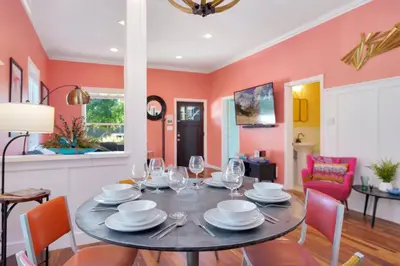 a dining room with a table with wine glasses at The Magnolia House in Old Town - Private Hot Tub in Fort Collins