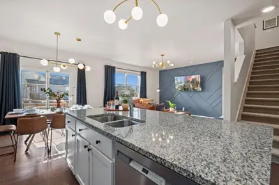 a kitchen and living room with a counter and a table at NEW! Family-friendly Home with Pool Table, King Beds in Windsor