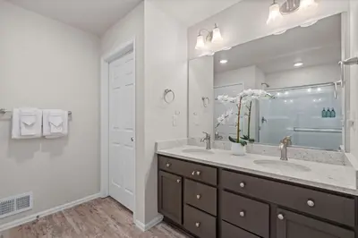 a bathroom with a sink and a large mirror at NEW! Family-friendly Home with Pool Table, King Beds in Windsor