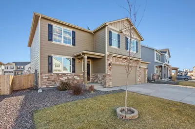 a house with a tree in the front yard at NEW! Family-friendly Home with Pool Table, King Beds in Windsor