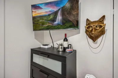 a painting of a cat with glasses on a wall at The Fox Den in Old Town! Pool, Sauna & Game Room in Fort Collins