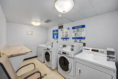 a laundry room with washing machines and a counter at The Fox Den in Old Town! Pool, Sauna & Game Room in Fort Collins