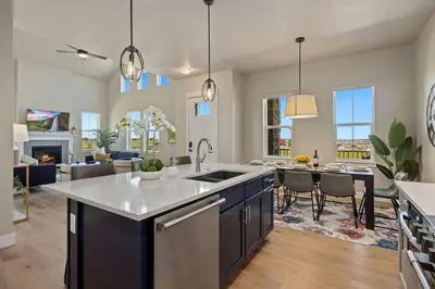 a kitchen and living room with a table and chairs at NEW! Elegant Home near TPC Golf Course & Trails in Loveland