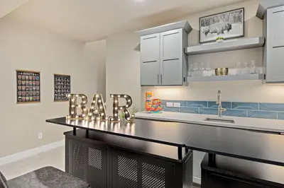 a kitchen with a bar with the letters ra at NEW! Elegant Home near TPC Golf Course & Trails in Loveland