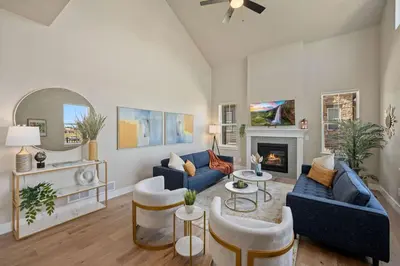 a living room with blue couches and a fireplace at NEW! Elegant Home near TPC Golf Course & Trails in Loveland