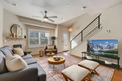 a living room with a couch and a flat screen tv at Urban Oasis near Breweries & Old Town - Free Bikes in Fort Collins