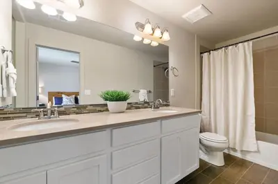a bathroom with a sink and a toilet and a mirror at Urban Oasis near Breweries & Old Town - Free Bikes in Fort Collins