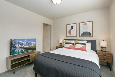 a bedroom with a large bed and a tv at Urban Oasis near Breweries & Old Town - Free Bikes in Fort Collins