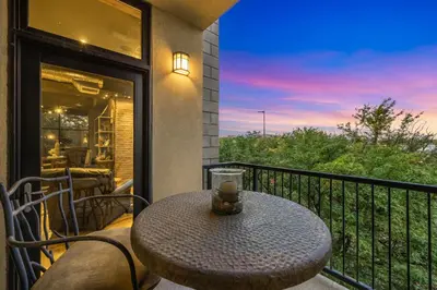 a table and chairs on a balcony with a view at Penthouse with Mountain Views in the Heart of Old Town in Fort Collins