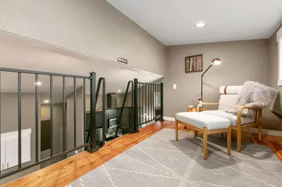 a living room with a couch and a chair at Luxury Living - Walk to Poudre Trail and Old Town! in Fort Collins