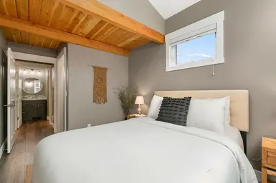 a bedroom with a white bed and a window at Luxury Living - Walk to Poudre Trail and Old Town! in Fort Collins