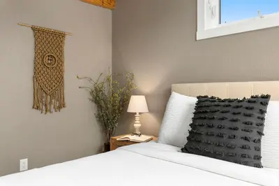 a bedroom with a bed with a pillow and a lamp at Luxury Living - Walk to Poudre Trail and Old Town! in Fort Collins