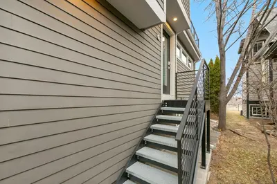 a set of stairs leading up to a house at Luxury Living - Walk to Poudre Trail and Old Town! in Fort Collins