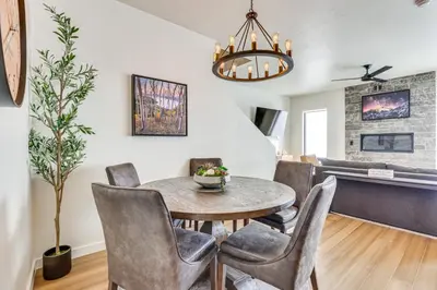 a dining room and living room with a table and chairs at Ski-InandSki-Out Granby Ranch Retreat Pool Access! in Granby