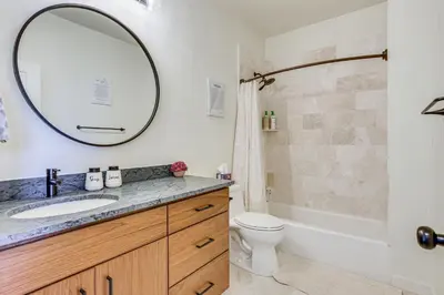 a bathroom with a sink and a toilet and a mirror at Ski-InandSki-Out Granby Ranch Retreat Pool Access! in Granby
