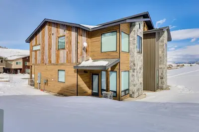 a wooden house in the snow in the snow at Ski-InandSki-Out Granby Ranch Retreat Pool Access! in Granby