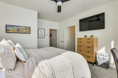 a bedroom with a bed and a television on the wall at Ski-InandSki-Out Granby Ranch Retreat Pool Access! in Granby