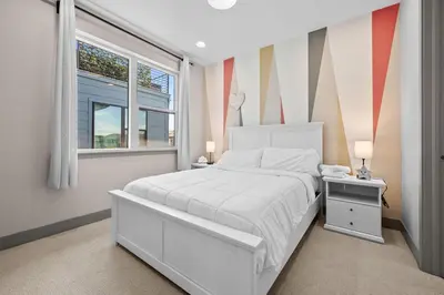 a bedroom with a white bed and a window at Orleans Street - Aurora in Aurora