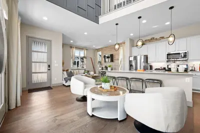 a kitchen and living room with a table and chairs at Orleans Street - Aurora in Aurora