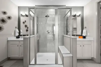 a shower with a glass door in a bathroom at Orleans Street - Aurora in Aurora
