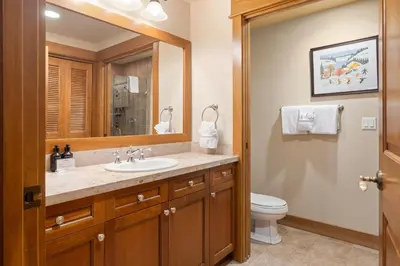 a bathroom with a sink and a toilet and a mirror at 3Br Ski-in Ski-out-On Mountain-Lone Eagle 3053 condo in Dillon