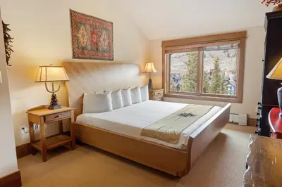 a bedroom with a large bed and a window at 3Br Ski-in Ski-out-On Mountain-Lone Eagle 3053 condo in Dillon