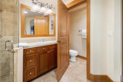a bathroom with a sink and a toilet and a mirror at 3Br Ski-in Ski-out-On Mountain-Lone Eagle 3053 condo in Dillon