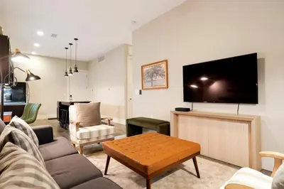 a living room with a couch and a flat screen tv at Unbeatable Location Golden Condo - Walk Everywhere in Golden