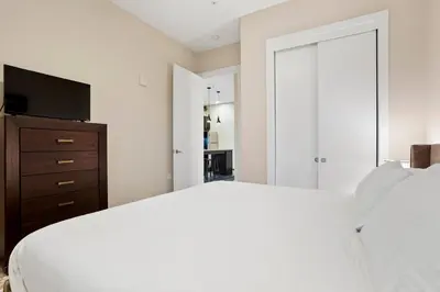 a bedroom with a bed and a dresser with a television at Unbeatable Location Golden Condo - Walk Everywhere in Golden