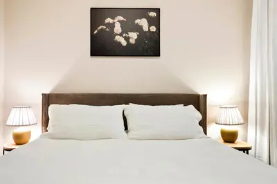 a bedroom with a white bed with two lamps at Unbeatable Location Golden Condo - Walk Everywhere in Golden