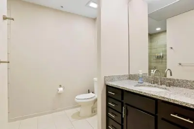 a bathroom with a toilet and a sink and a mirror at Unbeatable Location Golden Condo - Walk Everywhere in Golden