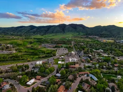 an aerial view of a small town with mountains in the background at Incredible Golden Location Close to Red Rocks and School of Mines in Golden