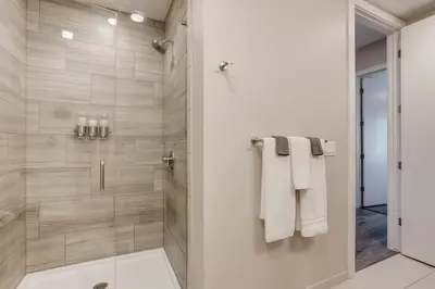 a bathroom with a walk in shower with a glass door at Incredible Golden Location Close to Red Rocks and School of Mines in Golden