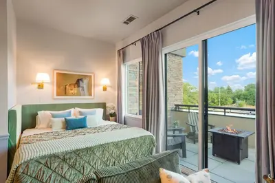 a bedroom with a bed and a balcony at Golden Condo Patio with MTN Views Walk to DT Golden and School of Mines in Golden