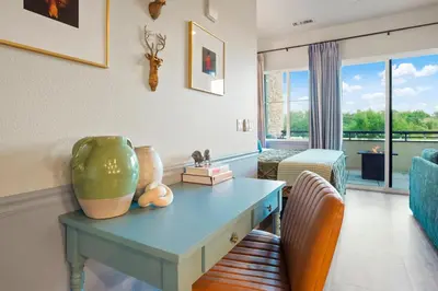 a living room with a table with a vase on it at Golden Condo Patio with MTN Views Walk to DT Golden and School of Mines in Golden