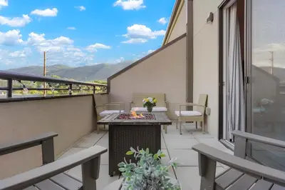a balcony with a table and a fire pit at Golden Condo Patio with MTN Views Walk to DT Golden and School of Mines in Golden
